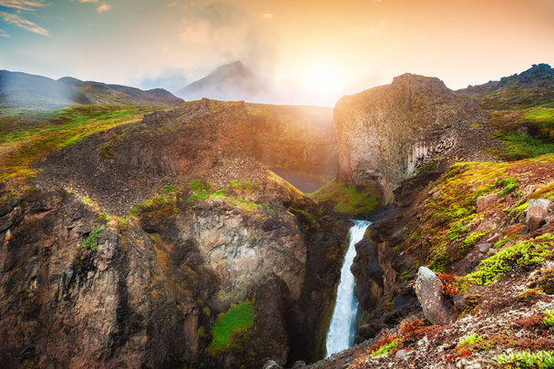 Beautiful waterfall in the mountains at sunset, Greenland - Photo, image