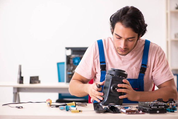 Young male contractor repairing computer   - Foto, immagini