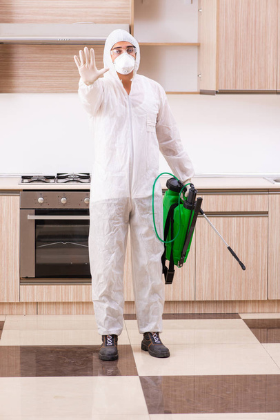 Professional contractor doing pest control at kitchen - Fotoğraf, Görsel