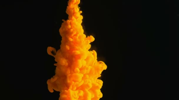 abstraktní pozadí oranžově zbarvené barvy, vstříkne se inkoust do vody na černém, podmořských kouřových kouři pohyb zblízka - Záběry, video