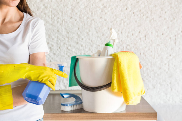 professional home cleaning. A young woman cleans the apartment. Close-up, rags, sponges and bucket, supplies staff. - Fotoğraf, Görsel