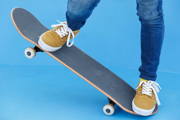 skateboarding legs riding skateboard at skatepark - Photo, image