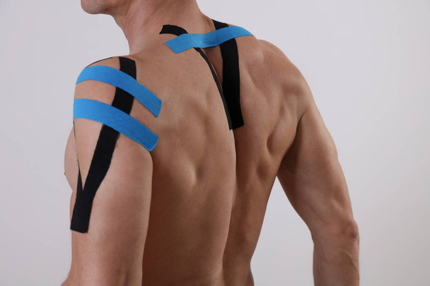 Kinesiology taping. Back pain, Sport man exercising injury. Alternative medicine concept - Zdjęcie, obraz