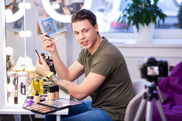 Experienced makeup artist with shaved brow looking on professional camera - Φωτογραφία, εικόνα