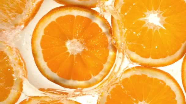 Super slow motion of orange slices with water splash. Filmed on high speed cinema camera, 1000 fps. - Footage, Video