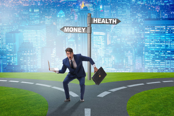 Biznesmen wybierający między pieniędzmi a zdrowiem - Zdjęcie, obraz