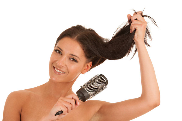 Beautiful ypoung woman combs her hair isolated over white backgr - Foto, Bild