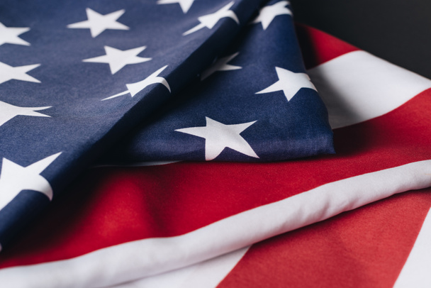 folded usa national flag isolated on black, memorial day concept - Foto, Bild