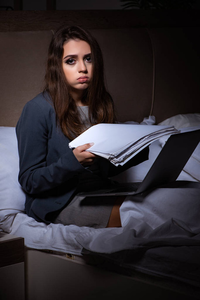 Tired businesswoman working overtime at home at night - Фото, изображение
