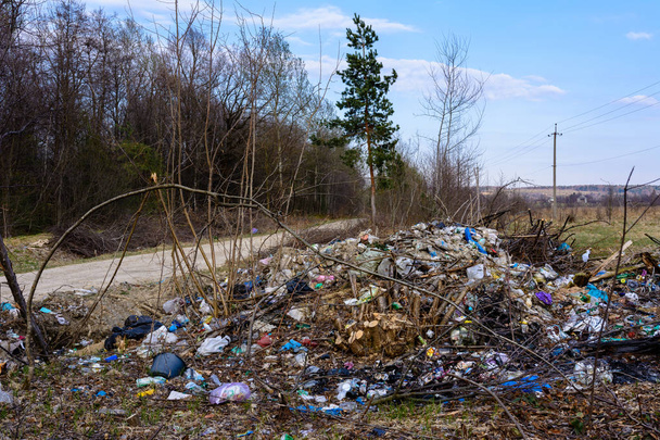 La basura es dispersada por la gente a través de los bosques y embalses, el desastre ecológico del planeta, la destrucción de la naturaleza y la vida silvestre
. - Foto, imagen