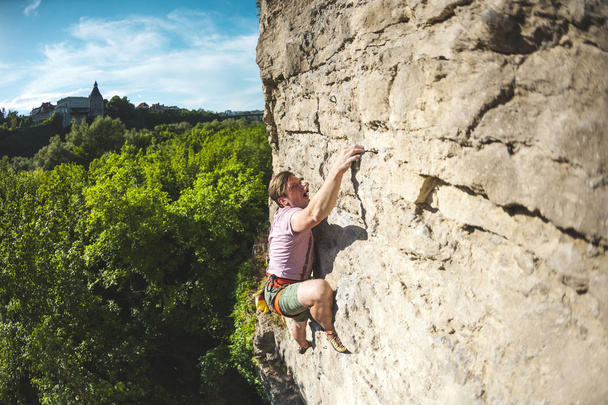 A man climbs the rock. - Photo, Image