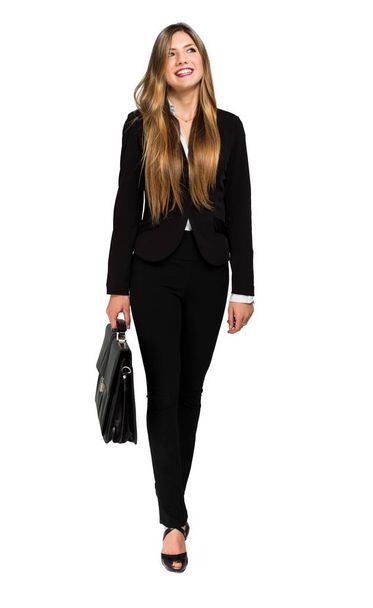 Young businesswoman portrait walking and holding a briefcase - Foto, Imagem