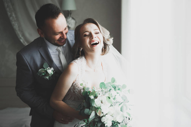 Lovely happy wedding couple, bride with long white dress - Foto, imagen