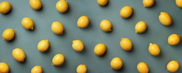 Food pattern with lemons on green paper background. Top view. Summer concept. Vegan and vegetarian diet. Banner - Фото, зображення
