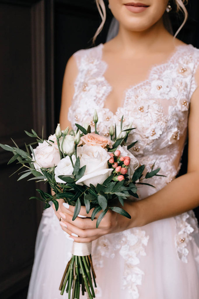 cropped shot of young bride in wedding dress holding beautiful bouquet  - Fotografie, Obrázek