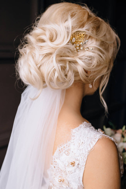 back view of beautiful young blonde bride with elegant hairstyle and veil - Foto, Imagen