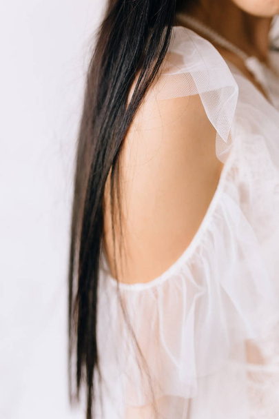 close-up view of beautiful young brunette bride in white dress, cropped shot - Photo, Image