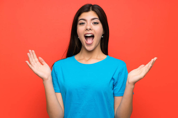 Teenager girl with blue shirt with surprise facial expression - Photo, Image