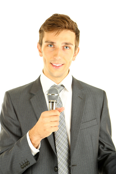 Young businessman talking with microphone, isolated on white - Фото, изображение
