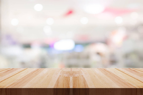 Empty wooden table top with blurred restaurant or cafe light background. - Photo, Image
