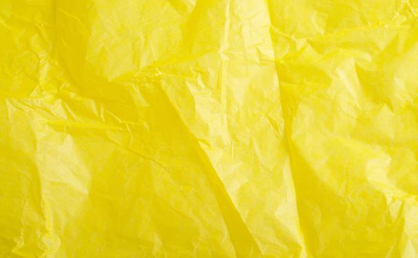 Yellow crumpled paper close-up. Bright background. texture - Фото, изображение