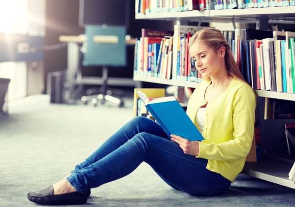 high school student girl reading book at library - Fotoğraf, Görsel