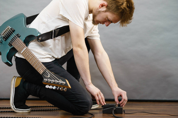 Man adjusting guitar effects pedal - Photo, Image