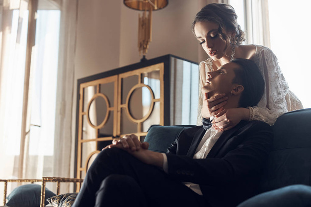 Young couple in luxury vintage clothes in hotel room. Wedding day. Elegance. Bride and groom. - 写真・画像