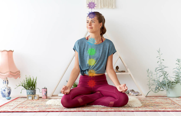 woman meditating in lotus pose at yoga studio - Φωτογραφία, εικόνα