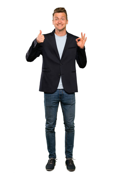 Blonde handsome man showing ok sign and thumb up gesture - Photo, Image