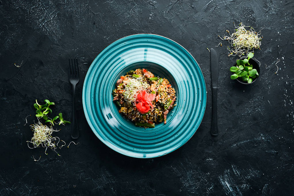 Risotto with veal and vegetables. Rice. In the plate. Top view. Free space for your text. Rustic style. - Photo, Image