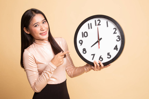 Young Asian woman point to a clock. - Foto, immagini