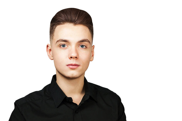Young white guy with a pompadour hairstyle dressed in black shirt with a serious face isolated on white background - Valokuva, kuva