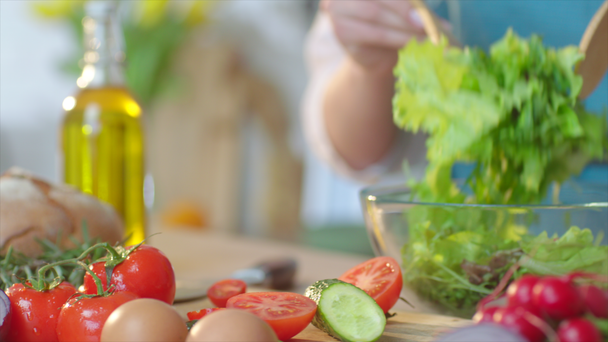 Close up woman cooking salad with greens at home - Footage, Video