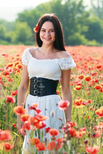 girl in poppies field - 写真・画像