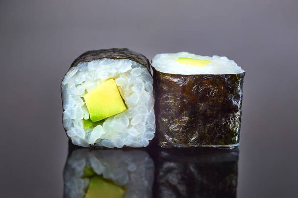 Classical vegan roll sushi with avocado on black background for menu. Japanese food - Fotografie, Obrázek