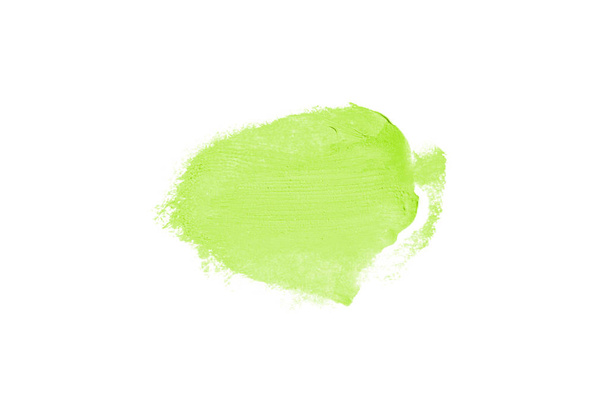 Smear and texture of lipstick or acrylic paint isolated on white background. Stroke of lipgloss or liquid nail polish swatch smudge sample. Element for beauty cosmetic design. Light green color - Photo, Image
