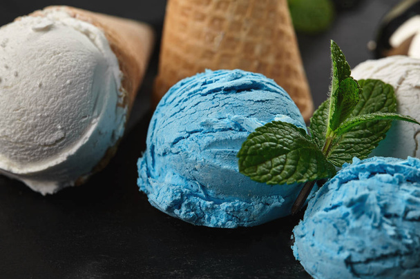 Close-up shot of a creamy and blueberry ice cream served on a dark slate, black background. - Photo, Image
