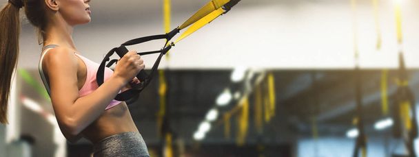 Trx training. Woman working out with fitness straps - Photo, Image