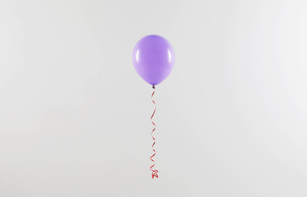 Bright balloon on light background. Celebration time - Zdjęcie, obraz