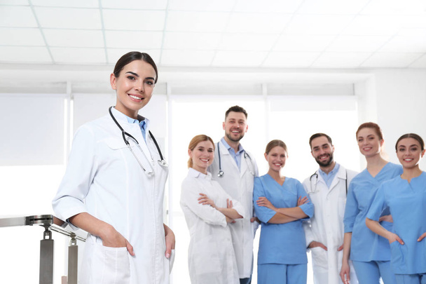 Young medical doctor with colleagues in clinic. Unity concept - Foto, Imagen
