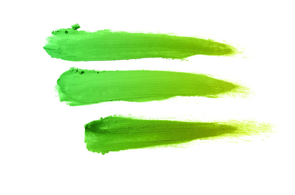 Abstrich und Textur von Lippenstift oder Acrylfarbe isoliert auf weißem Hintergrund. grün-gelbe Farbe - Foto, Bild