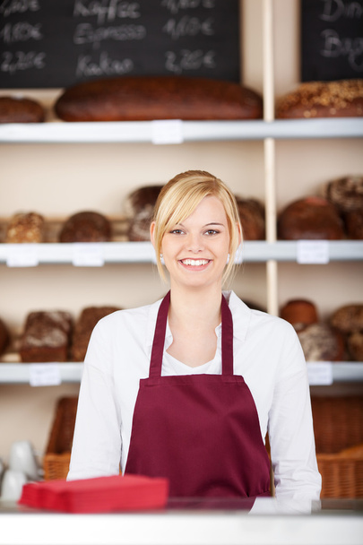 confident saleswoman in bakery - Foto, imagen