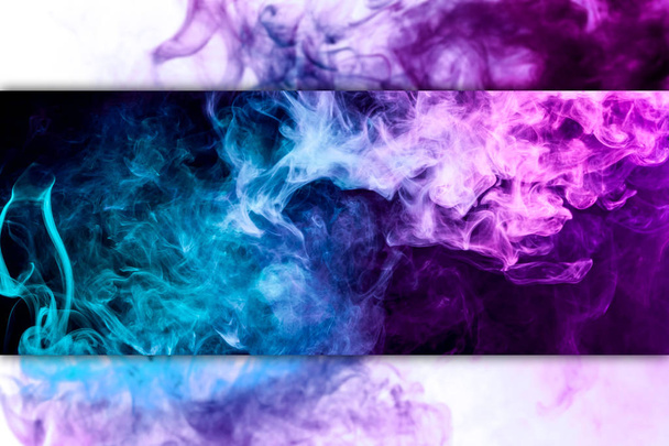 Abstract art colored  blue and pink smoke on black isolated background. Stop the movement of multicolored smoke on black and white backgroun - Photo, Image