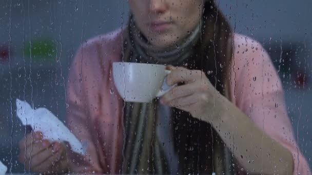 Lady suffering flu, drinking hot beverage and sneezing, influenza epidemics - Materiał filmowy, wideo