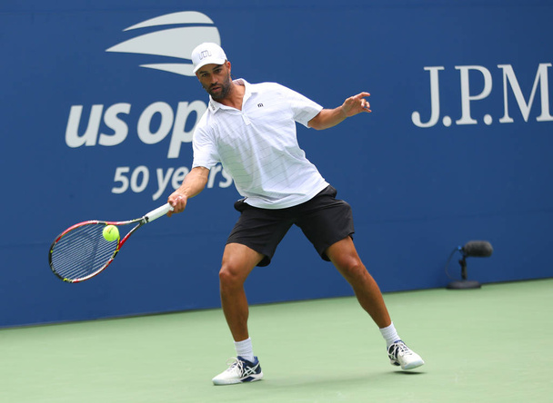 NEW YORK - AUGUST 22, 2018: American retired professional tennis player James Blake in action during 2018 US Open exhibition match at newly open Louis Armstrong Stadium at National Tennis Center - Photo, Image
