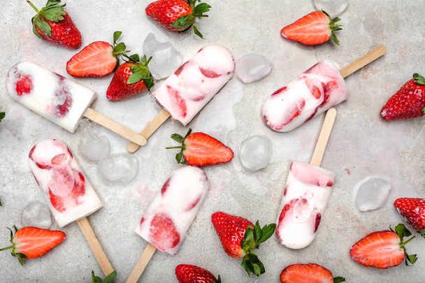 Homemade popsicles with strawberries, ice lollies on sticks, top view, flat lay - Фото, изображение