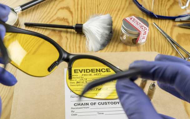 Basic research utensils with a evidence bag in Laboratorio forensic equipment, conceptual image - Photo, Image