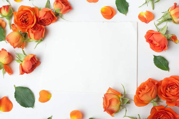 Framework from orange roses on white background. Flat lay. Top view - Foto, Imagem