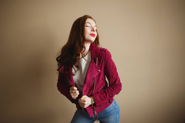 Young hipster woman clothed in magenta jacket. Beautiful eyes, long brown curly hair - Фото, изображение